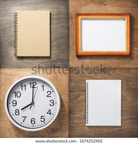 checked notebook and wall clock at wooden background
