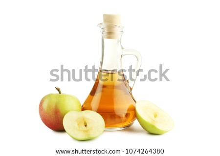 Apple vinegar in glass bottle isolated on white Royalty-Free Stock Photo #1074264380