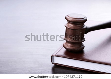 Judge gavel with book on wooden table
