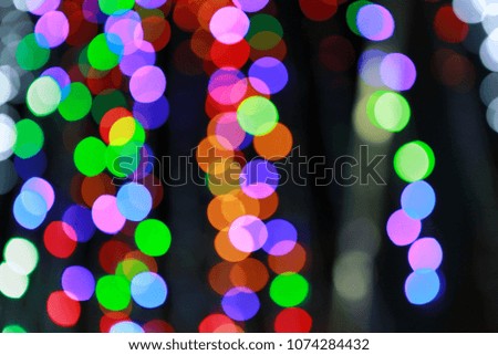 Abstract colored bokeh light on black background.
