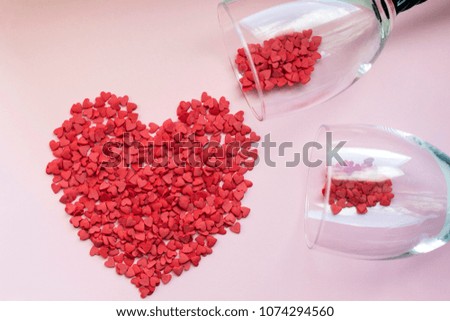 Heart made of confetti, glasses with confetti, pink background, love, anniversary