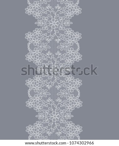 white lace ribbon with floral pattern on a gray background