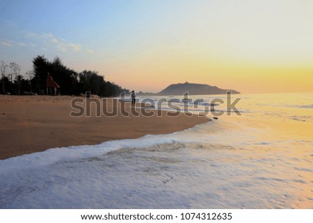 Children playing on the beach at the sunset time. Thailand.