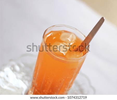 Glass of fresh pure orange juice drink with ice cube  