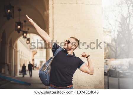 Happy student with arms raised on air