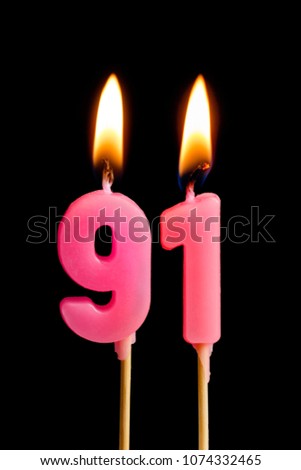 Burning candles in the form of 91 ninety one (numbers, dates) for cake isolated on black background. The concept of celebrating a birthday, anniversary, important date, holiday, table setting