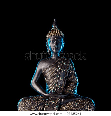 Buddha statue with glow against black background