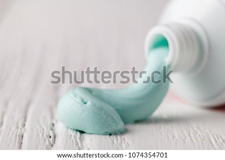 Toothpaste squeezed out from a toothpaste tube Royalty-Free Stock Photo #1074354701