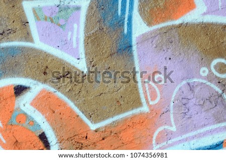 The old wall, painted in color graffiti drawing red aerosol paints. Background image on the theme of drawing graffiti and street art