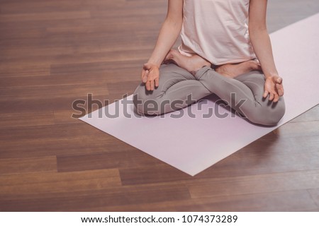 Young woman in lous pose on the floor