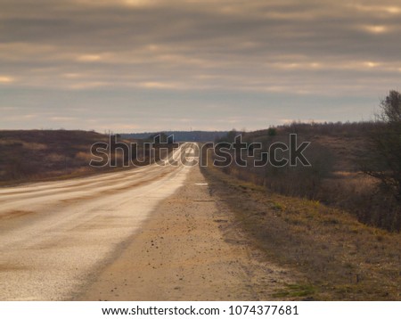 High-speed highway leaving towards the horizon through the flat terrain