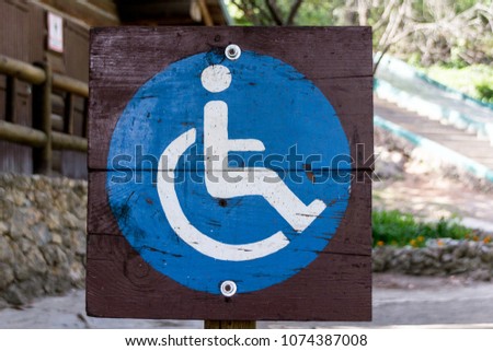 Photograph of a wood handicapped sign at forest