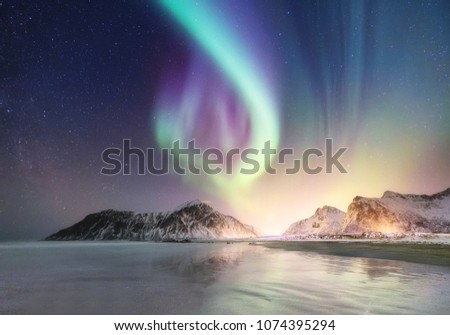 Northen light on the arctic beach. Beautiful natural landscape in the Norway Royalty-Free Stock Photo #1074395294
