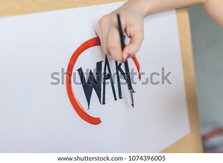 the girl writes the word war in the red circle