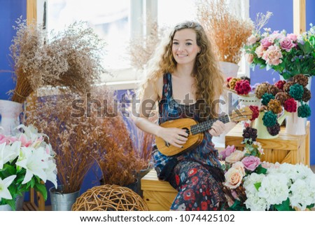 Beautiful girl playing ukulele