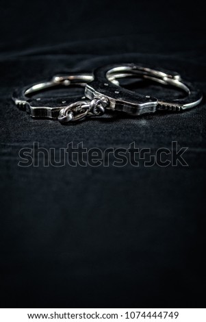 metal handcuffs with black background