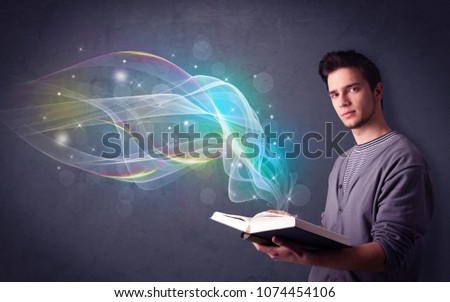 Casual young man holding book with rainbow waves flying out of it