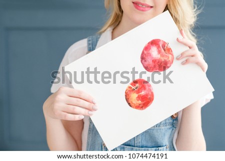 creative leisure. painting hobby. artful personality. talented girl holding her watercolor drawing of apples