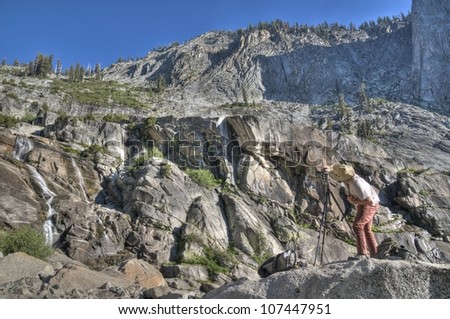 A nature photographer taking a photo of Topekah Falls in Sequoia National Park.