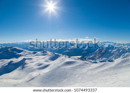 View from summit Cime de Caron (3200 m.) France, the Worlds largest skiing area. Royalty-Free Stock Photo #1074493337