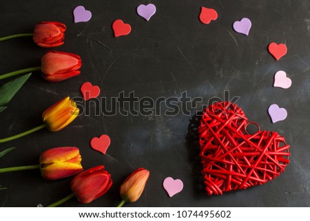A lot of red tulips on a wooden background