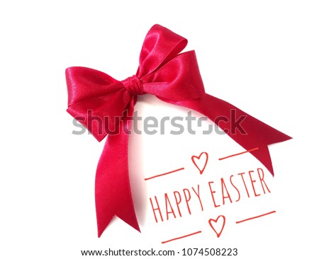 Closeup top view of red ribbon/bow with HAPPY EASTER banner on white background.
