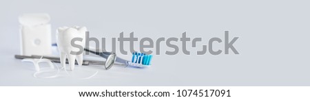 White healthy tooth, different tools for dental care. Dental background. Royalty-Free Stock Photo #1074517091