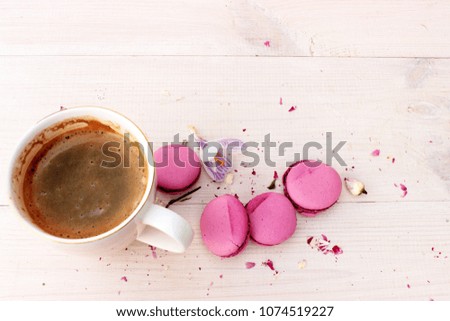 Very cute and lovely composition with cup of fresh hot coffee and some sweet french cakes on white wooden background. Overhead view. Concept for romantic "good morning" theme. Copy space