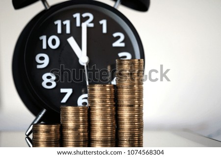 Step of coins stacks and alarm clock with tablet computer and financial graph, business planning vision and finance analysis concept idea.