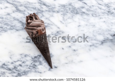 Double Chocolate Ice Creams with Black Waffle Cones on Marble Background