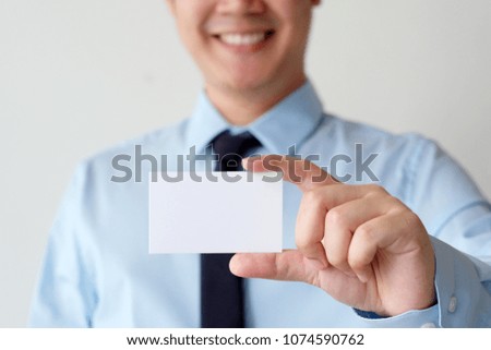 Businessman hand holding blank white business card with copy space for text, business mock up background concept 