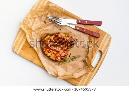 A grilled ribeye steak with sauce