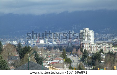 Vancouver city street view with downtown and Northshore mountains in the background