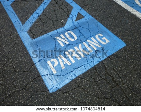 painted blue no parking sign in a parking lot