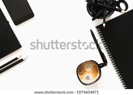 Creative white office desk with black office supplies, glasses, notebook, coffee cup, pen, glasses. Flat lay, top view, copy space