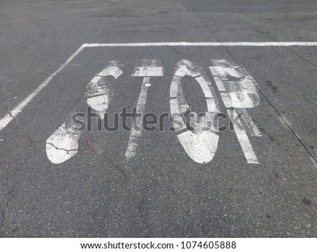 painted stop sign in a parking lot
