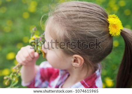 Portrait of cute little girl with a dandelions.