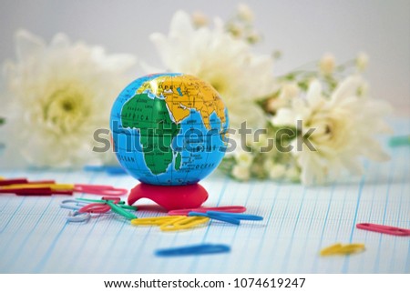 Hello School. Hello, September. Globe and stationery on a background of autumn colors. This time for the school, September 1. Can be used as a background image that copies space.