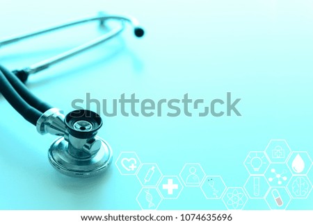 Medical Background Concept. Stethoscope on doctor desk with science hexagon and medical icons in background.