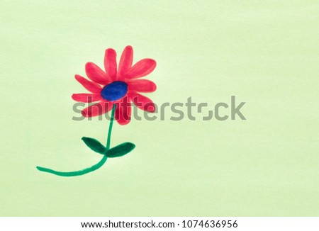 child's drawing of a red flower with a purple center on a pale green background with copy space