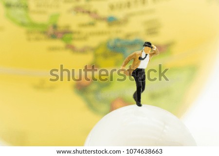 Miniature people : Businessman standing with world map. Image use for business and travel concept.