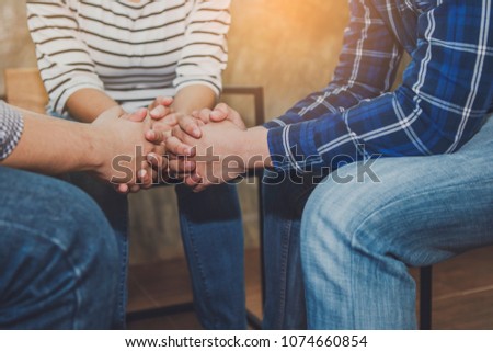 group of christian people praying together in home, trust concept , christian background