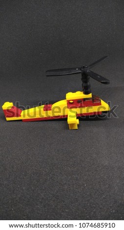 the mini yellow helicopter.  the yellow helicopter with yellow,  black and red colour. 