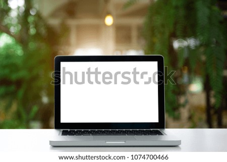 Conceptual workspace,Empty space white desk on Laptop screen Interior at cafe blurred background of light bokeh.