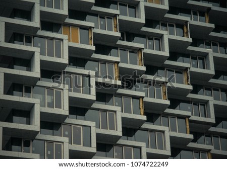 white, blue and orange hotel windows in an orderly fashion. symmetry, popping  out many windows, texture
