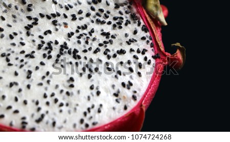 Dragon fruit slice close up. Juicy pink pitaya seeds. 