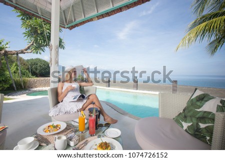 Woman relaxing at the poolside and sea view with morning coffee breakfast sunny day outdoor girl at exotic resort