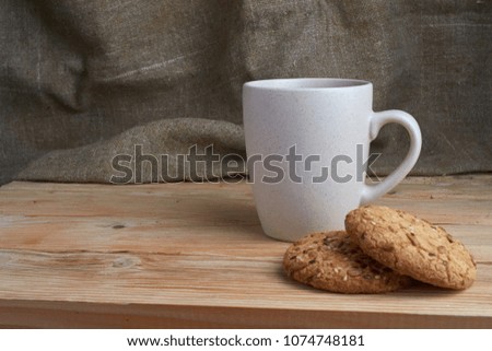 homemade oat cookies with sunflower seeds in basket and cup of tea