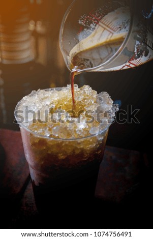 Pouring coffee from a cup Poured over ice