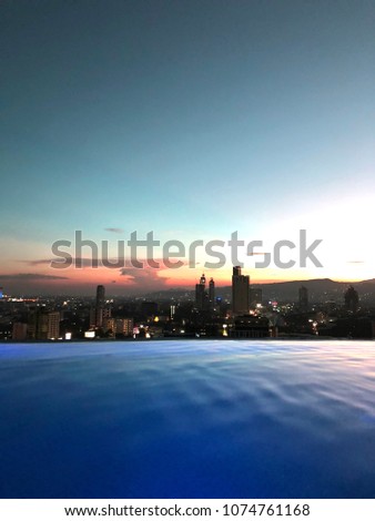 Roof Infinity Pool with Colored Sunset View